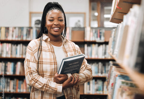 Portrait, black woman and library with book, knowledge and relax with free time. Nigerian female, student smile and customer in bookstore, for reading and literature for education, study and research